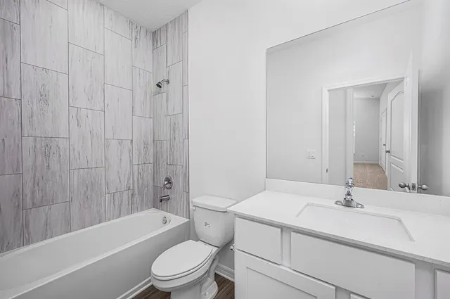 a bathroom with a sink a toilet and a bathtub