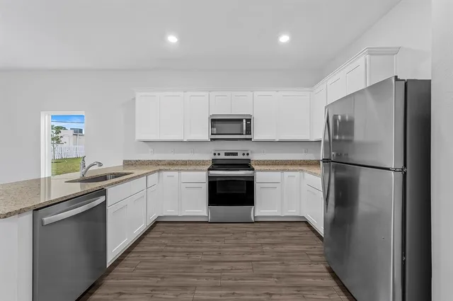 a kitchen with a refrigerator and a sink