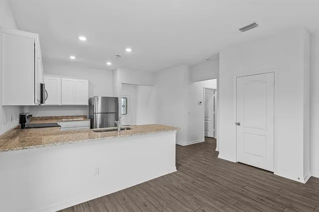 a kitchen with kitchen island a sink appliances and a counter space