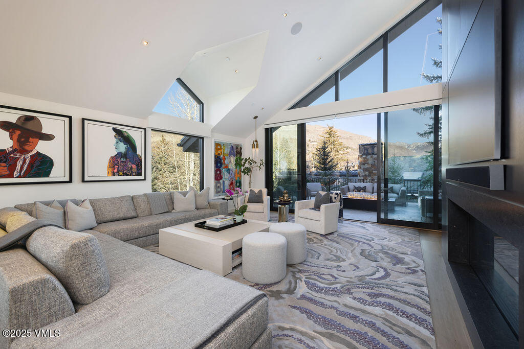 254 Beaver Dam Road Vail, CO 81657 - Photo 6 of 46 a living room with fireplace furniture and a large window