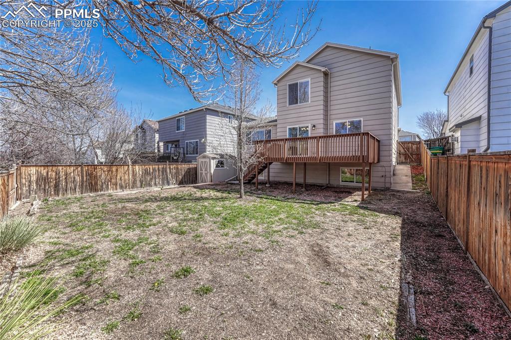 Undisclosed Address Castle Rock, CO 80109 - Photo 5 of 11 a view of a house with a yard and wooden fence