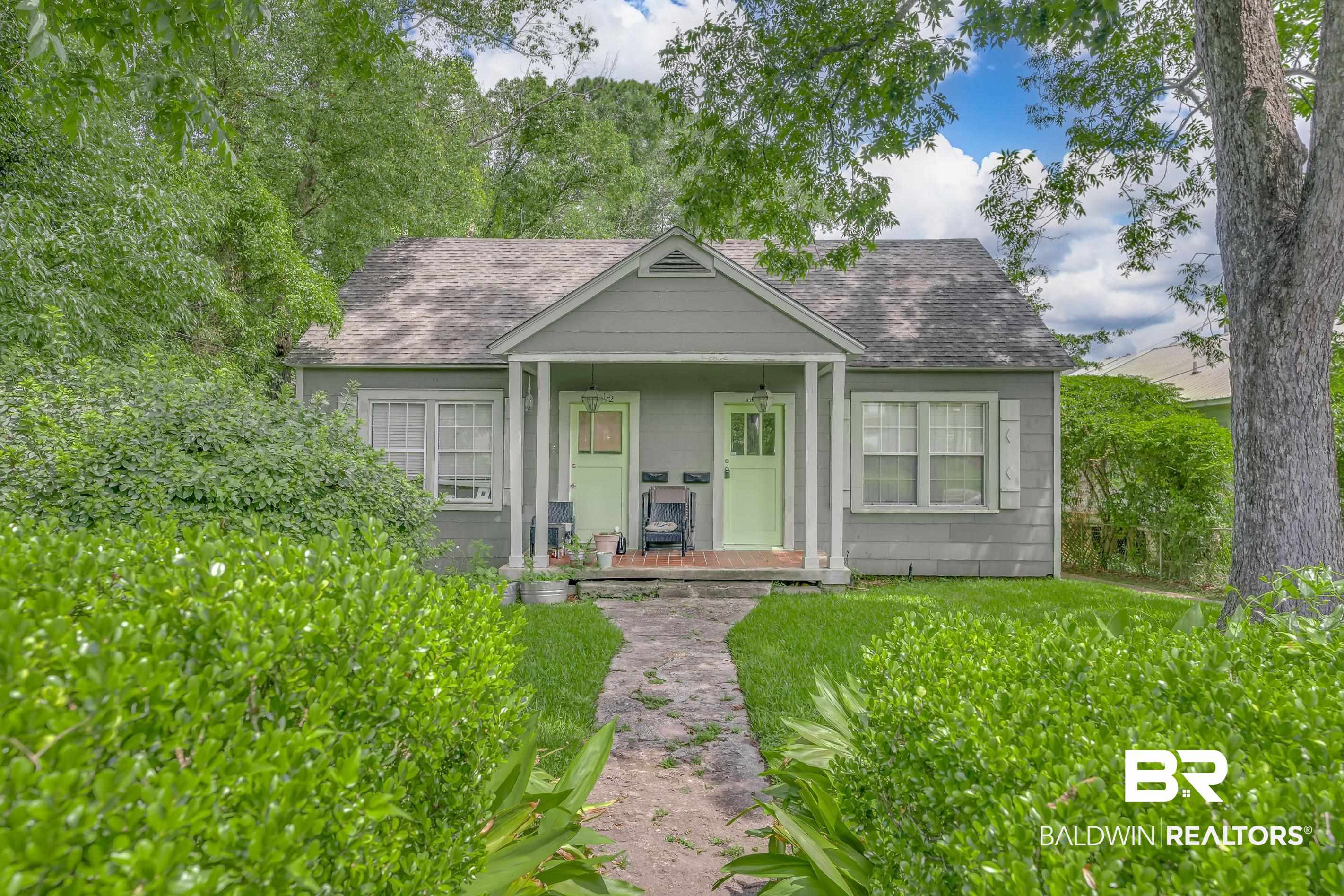Bungalow featuring a shingled roof and covered porch