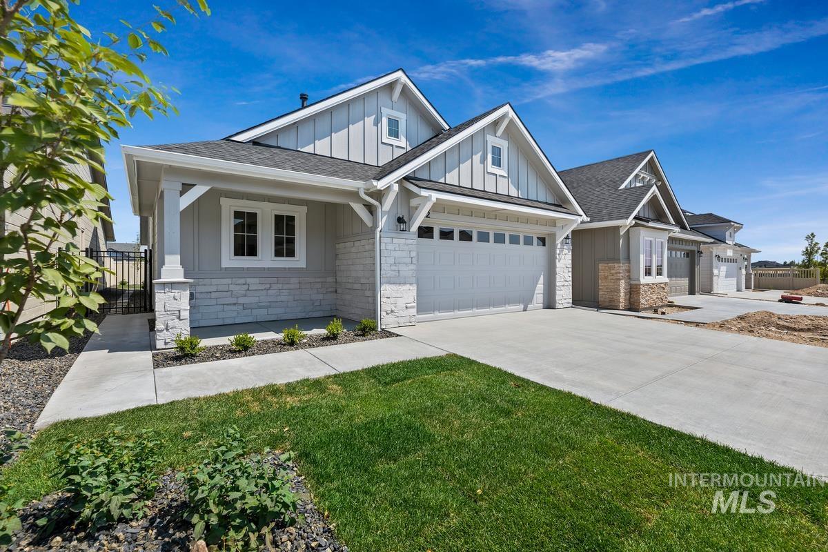 Craftsman-style home featuring board and batten siding, roof with shingles, concrete driveway, a porch, and an attached garage