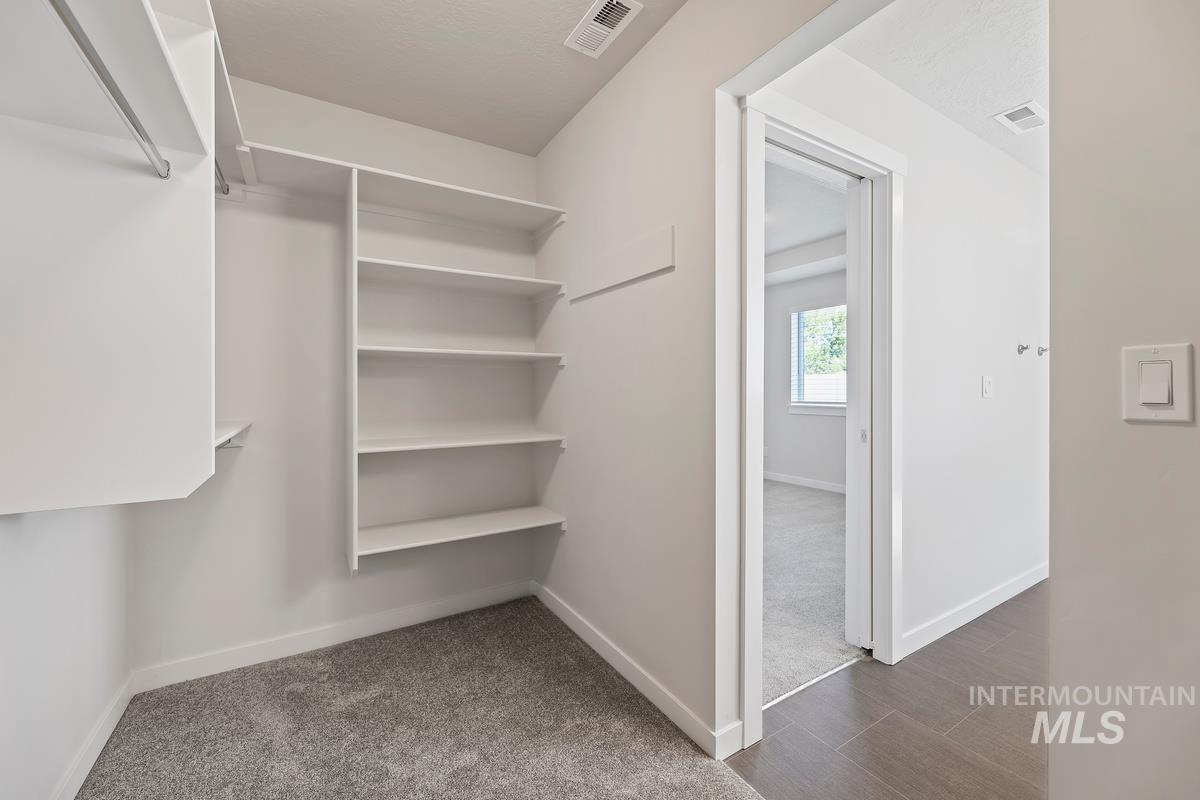 212 East Radiant Ridge Drive Meridian, ID 83642 - Photo 19 of 36 Walk in closet featuring dark colored carpet