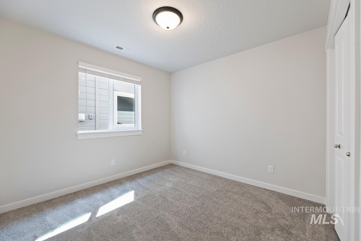 212 East Radiant Ridge Drive Meridian, ID 83642 - Photo 22 of 36 Spare room featuring baseboards and carpet floors