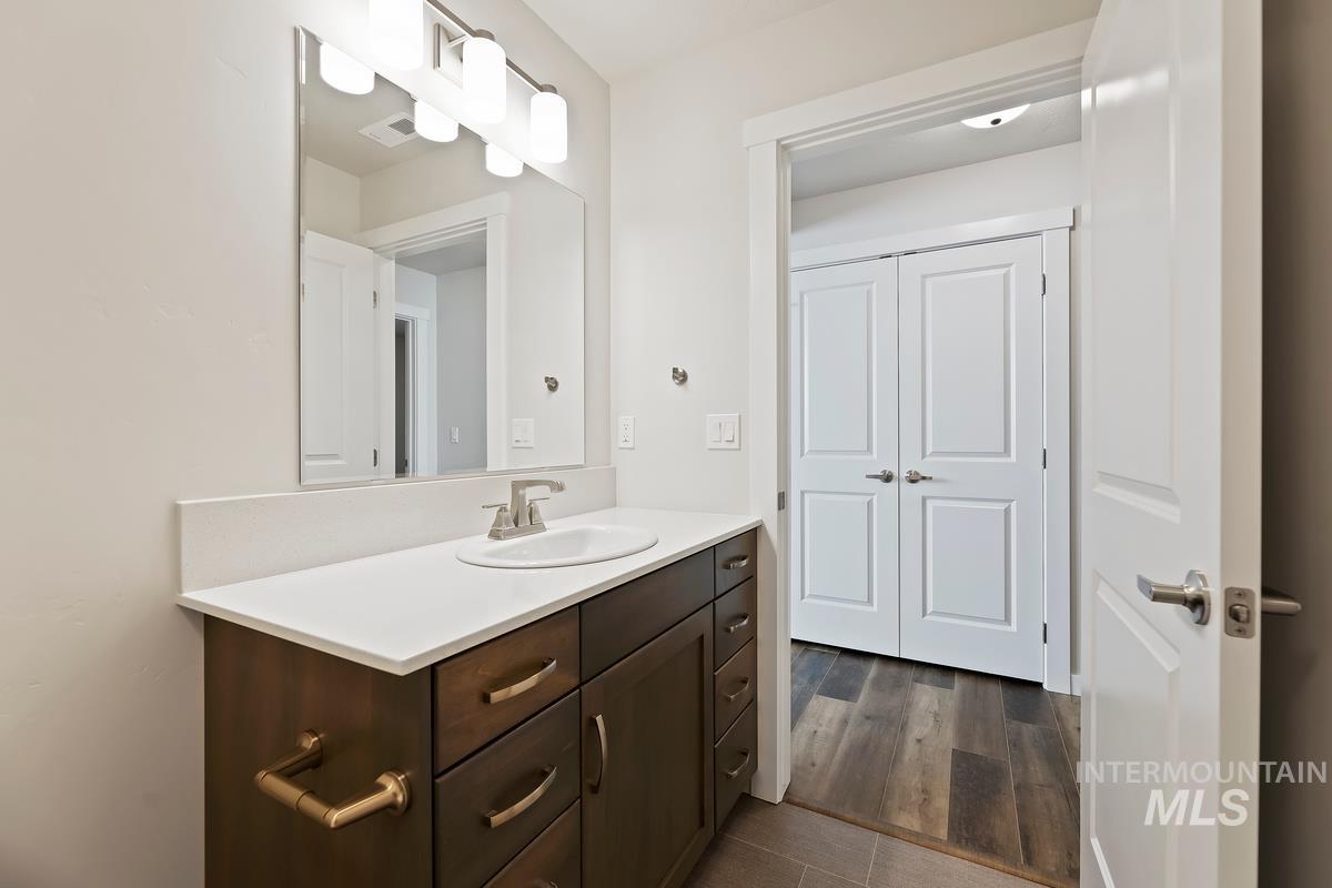 212 East Radiant Ridge Drive Meridian, ID 83642 - Photo 25 of 36 Bathroom featuring vanity and dark wood-style flooring