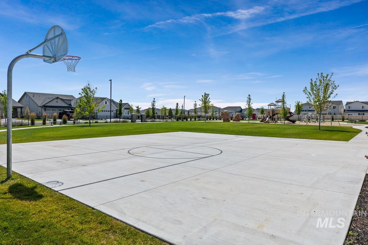 212 East Radiant Ridge Drive Meridian, ID 83642 - Photo 32 of 36 View of sport court with community basketball court, a yard, and a residential view