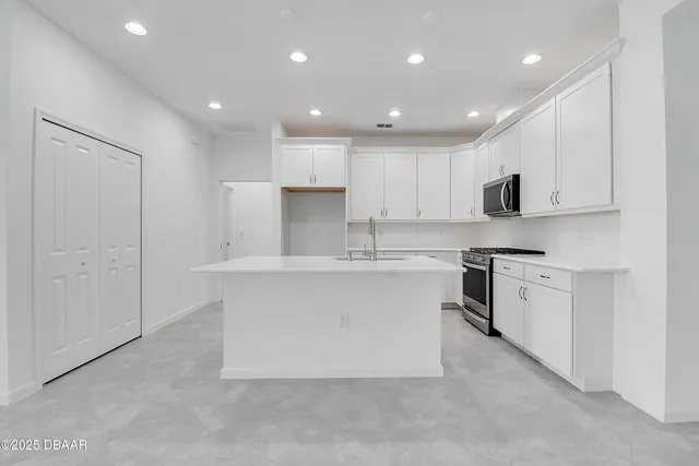 an aerial view of a house with a garden and lake view