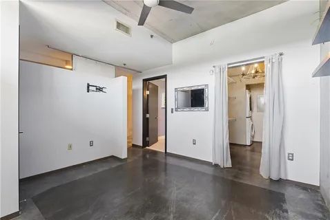 a bathroom with a granite countertop sink a toilet a mirror and bathtub