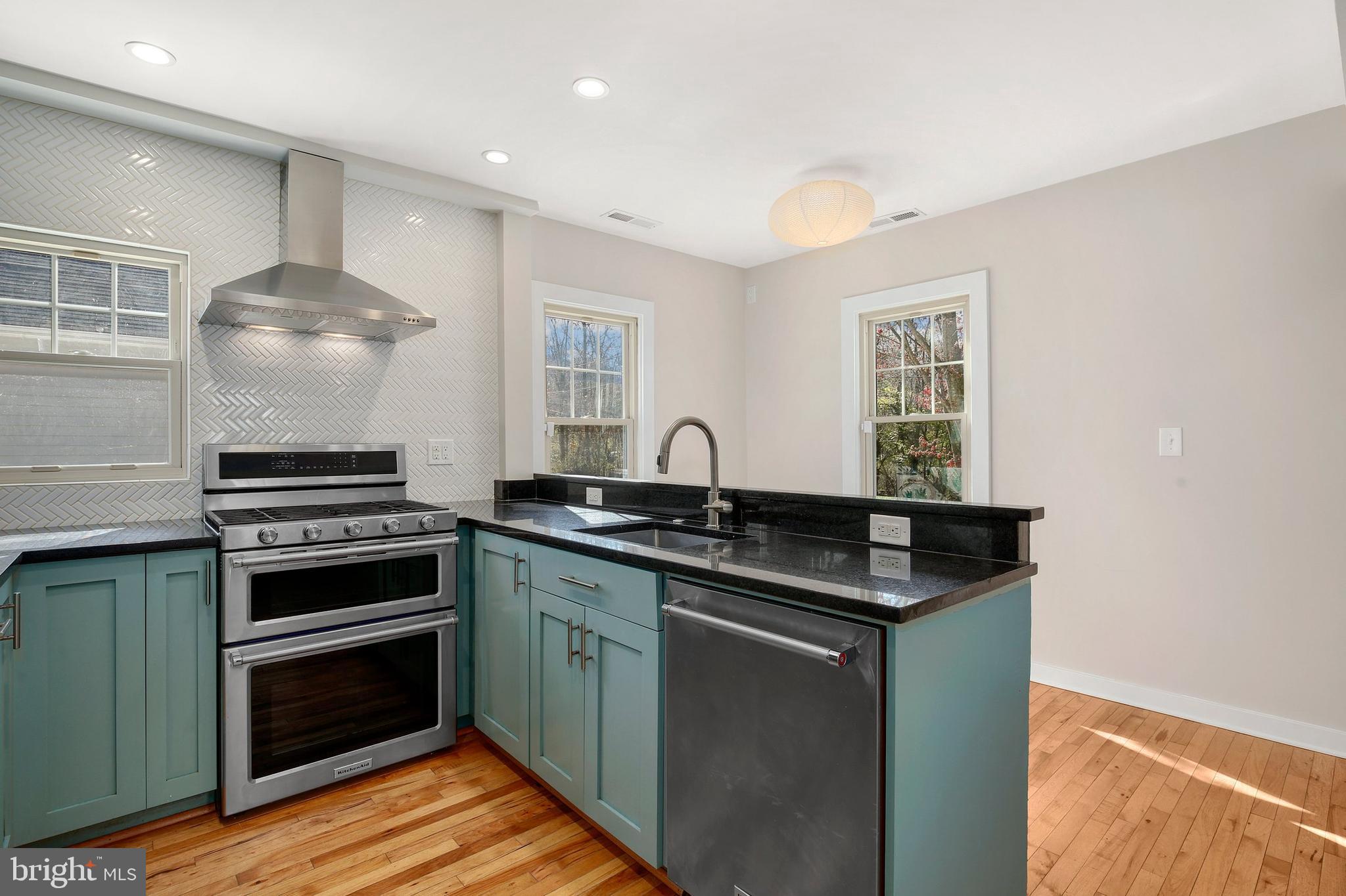 304 Marshall Street Gaithersburg, MD 20877 - Photo 15 of 38 a kitchen with granite countertop a sink cabinets and stainless steel appliances