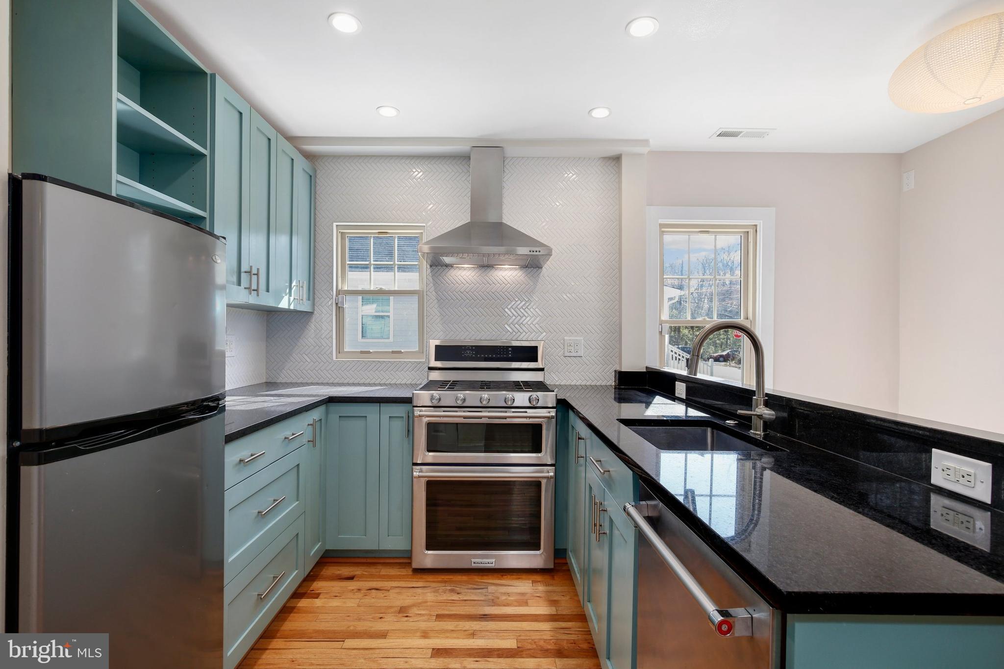 304 Marshall Street Gaithersburg, MD 20877 - Photo 16 of 38 a kitchen with granite countertop a stove sink and cabinets