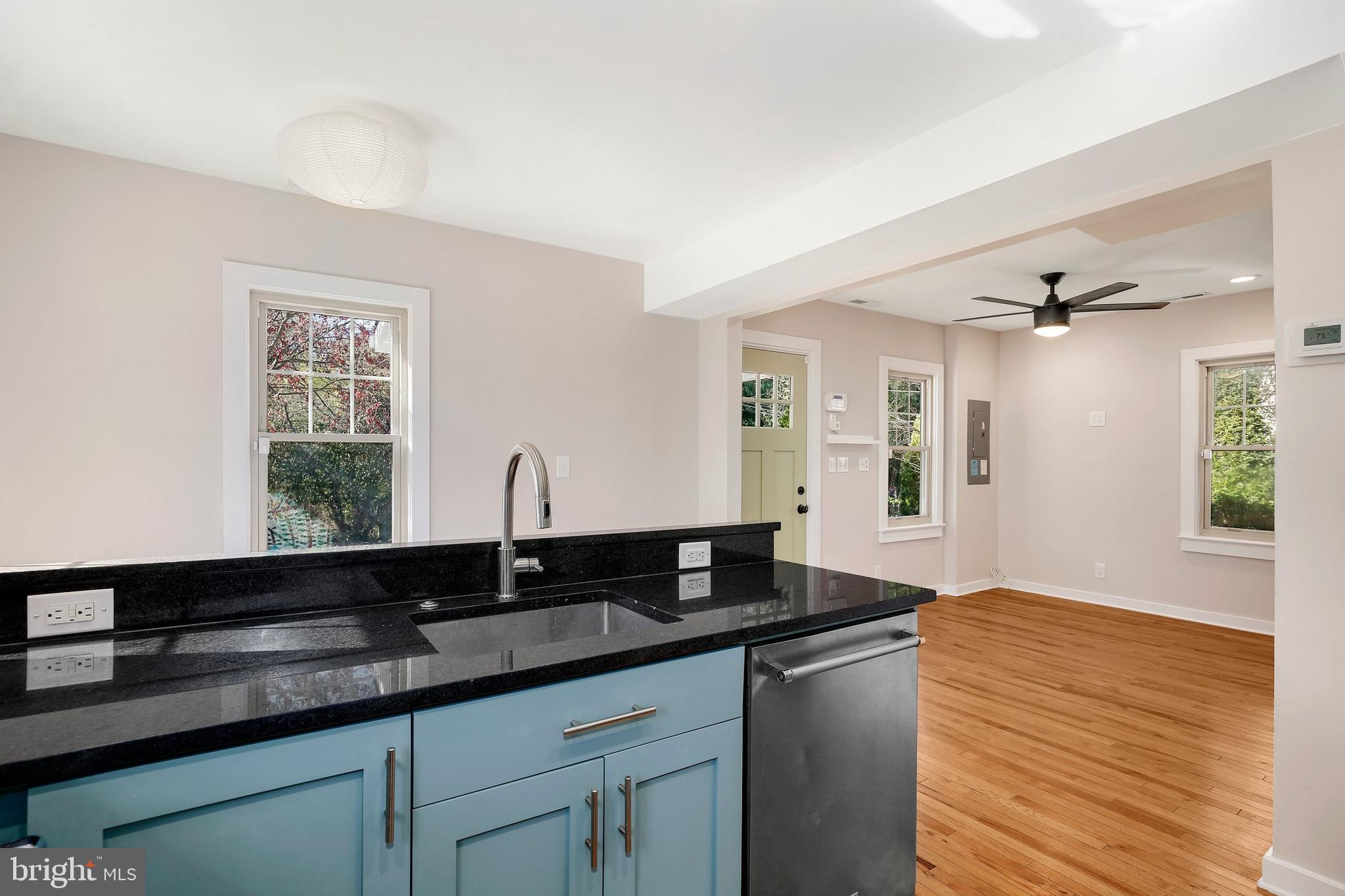 304 Marshall Street Gaithersburg, MD 20877 - Photo 17 of 38 a kitchen with granite countertop a sink cabinets and wooden floor