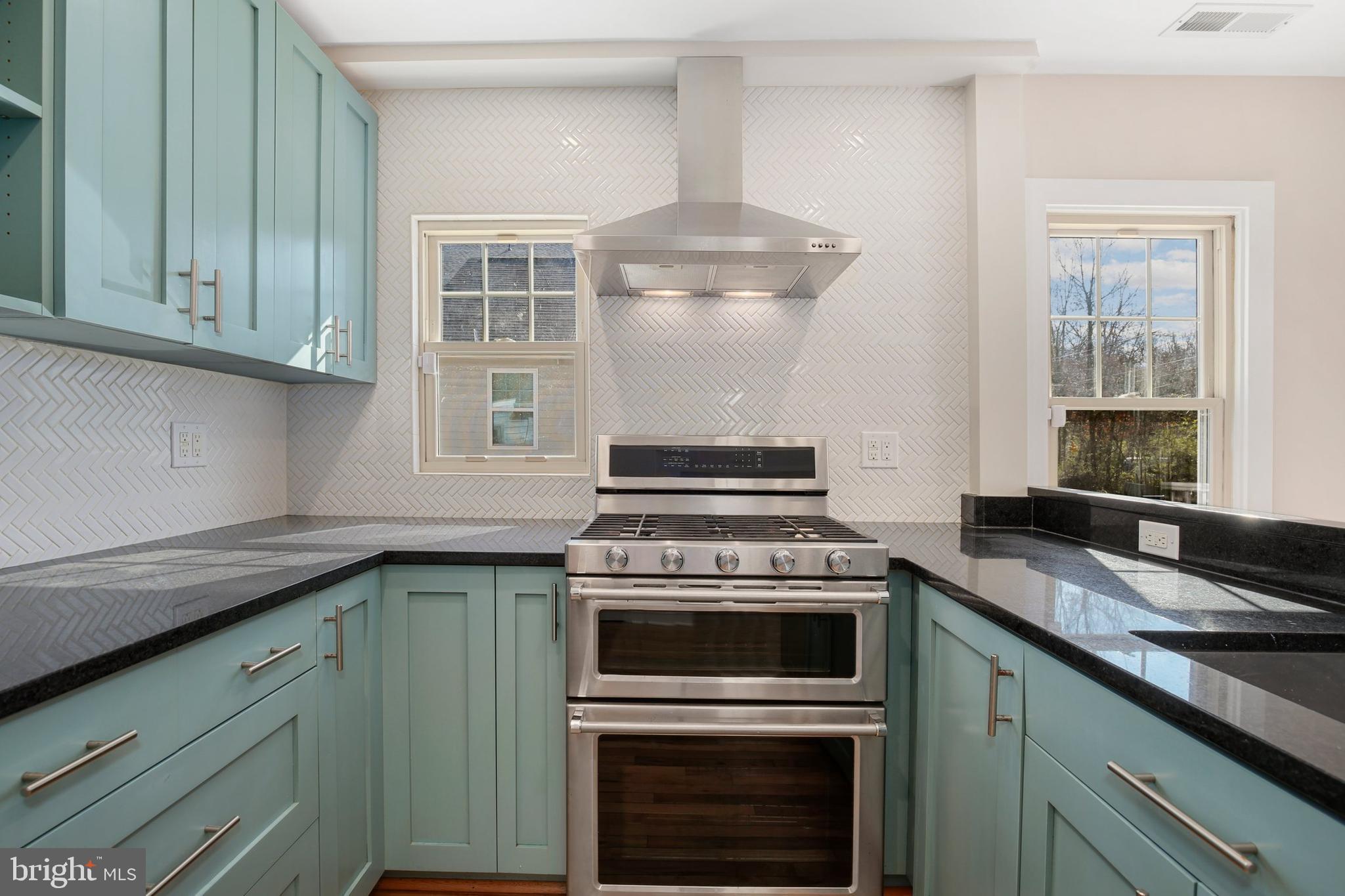 304 Marshall Street Gaithersburg, MD 20877 - Photo 18 of 38 a kitchen with granite countertop a stove sink and cabinets