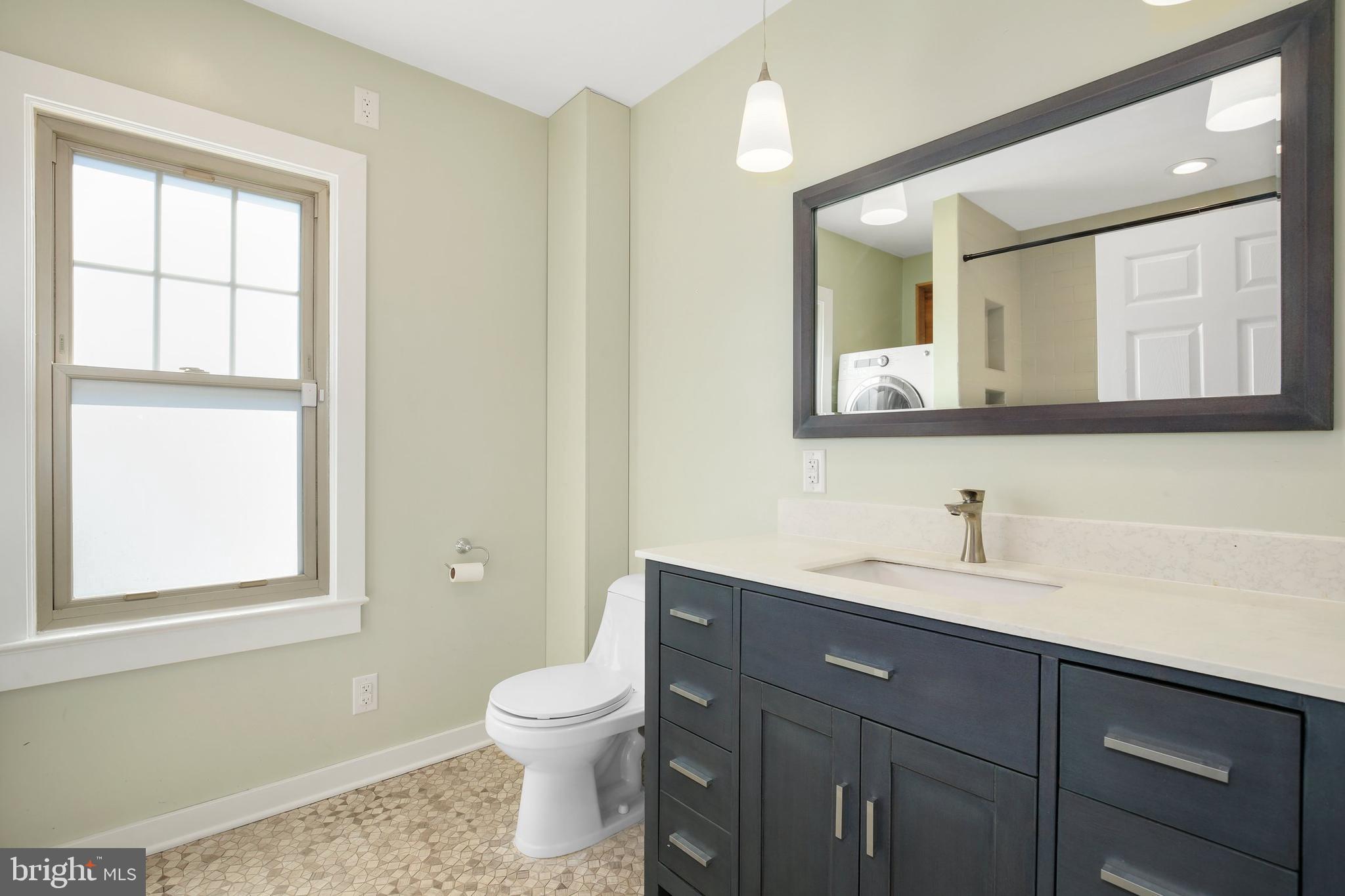 304 Marshall Street Gaithersburg, MD 20877 - Photo 24 of 38 a bathroom with a toilet sink and mirror