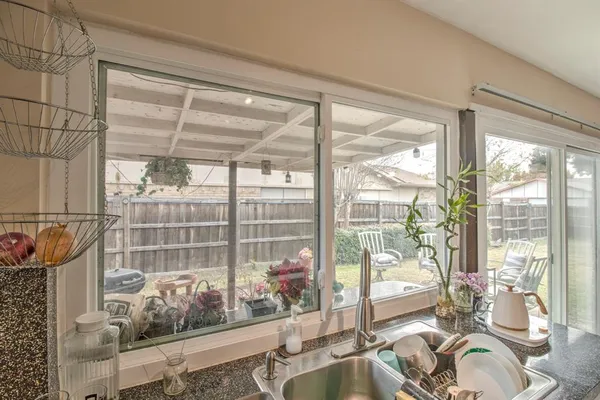 a room with a large window and furniture