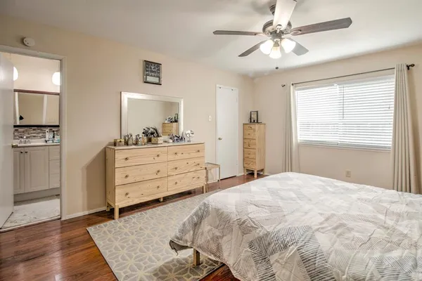 a bedroom with a bed and a dresser