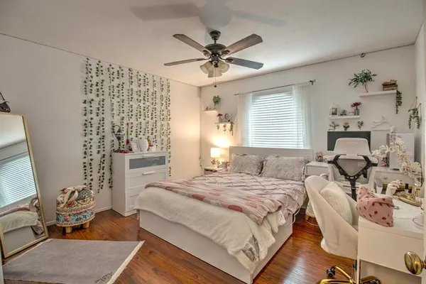 a bedroom with a bed and wooden floor