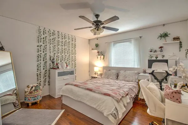 a bedroom with a bed and wooden floor