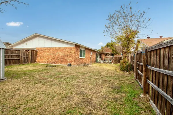 a view of a house with backyard and tree