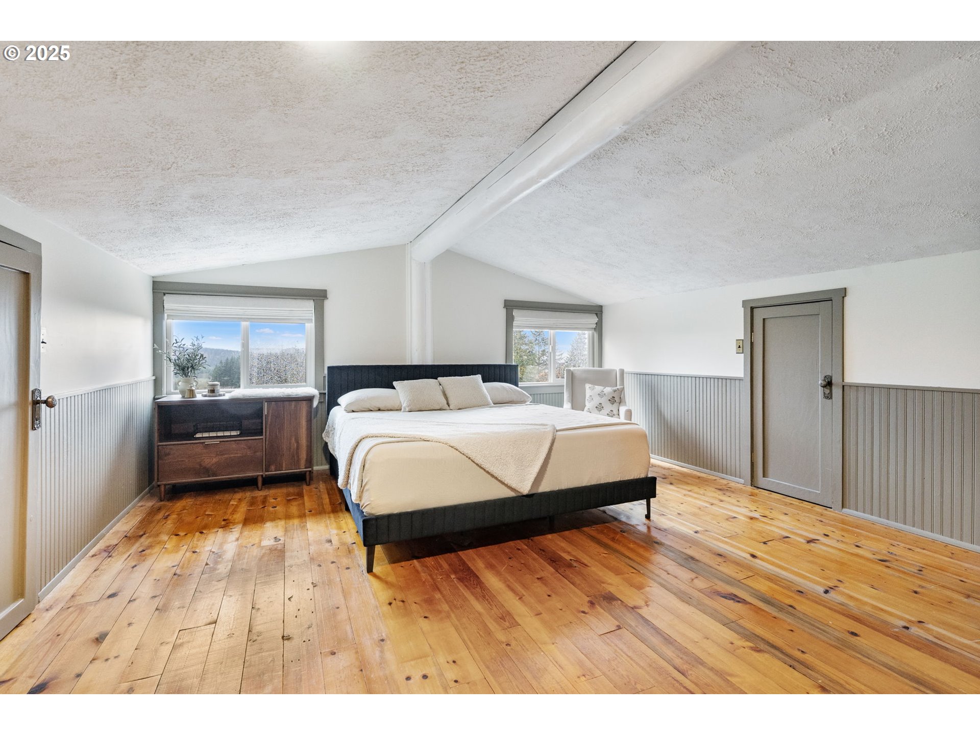 25751 Southeast Brian Ranch Road Sandy, OR 97055 - Photo 17 of 44 a bedroom with a bed and wooden floor