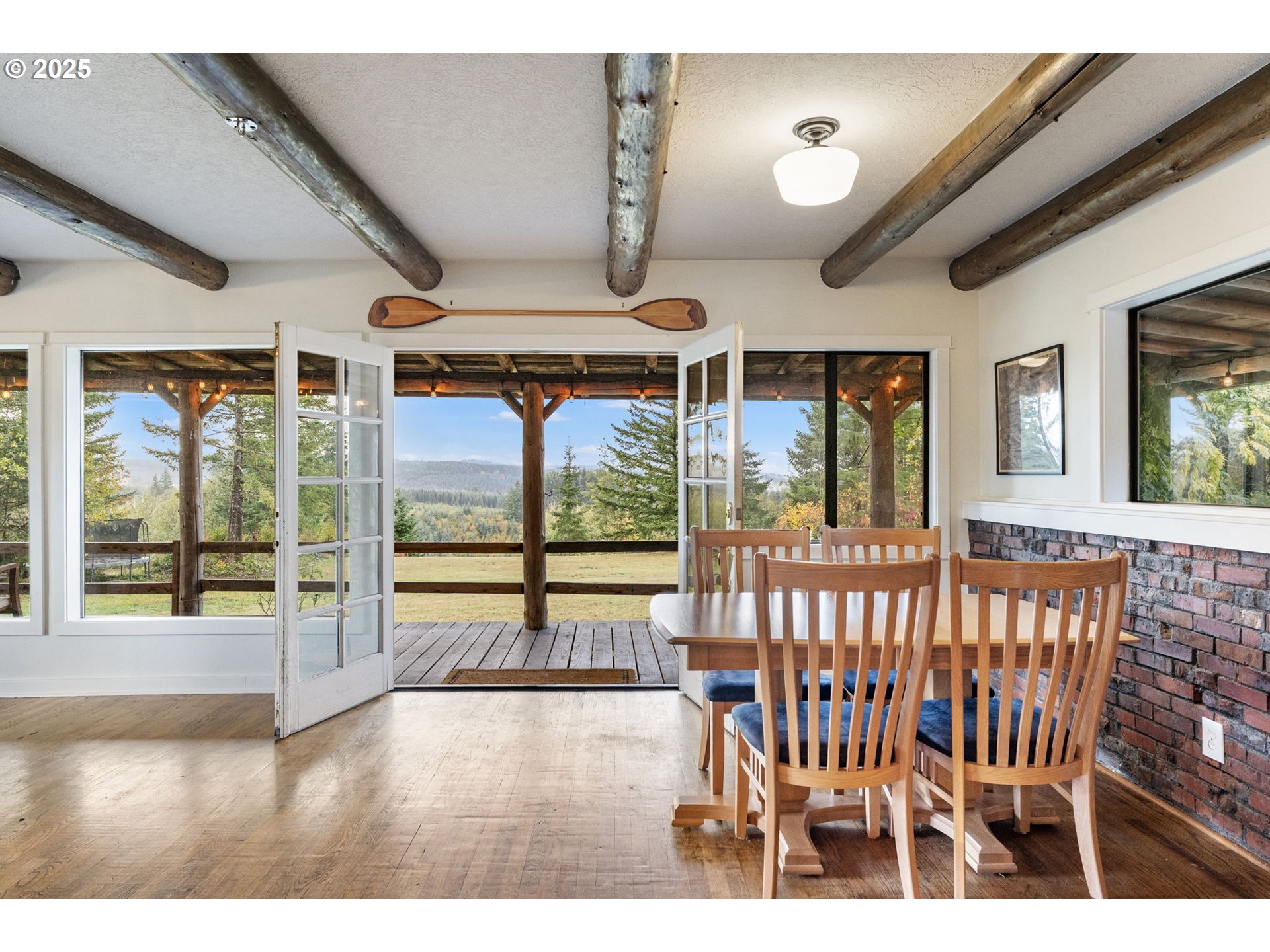 25751 Southeast Brian Ranch Road Sandy, OR 97055 - Photo 9 of 44 a view of an empty room with wooden floor and windows