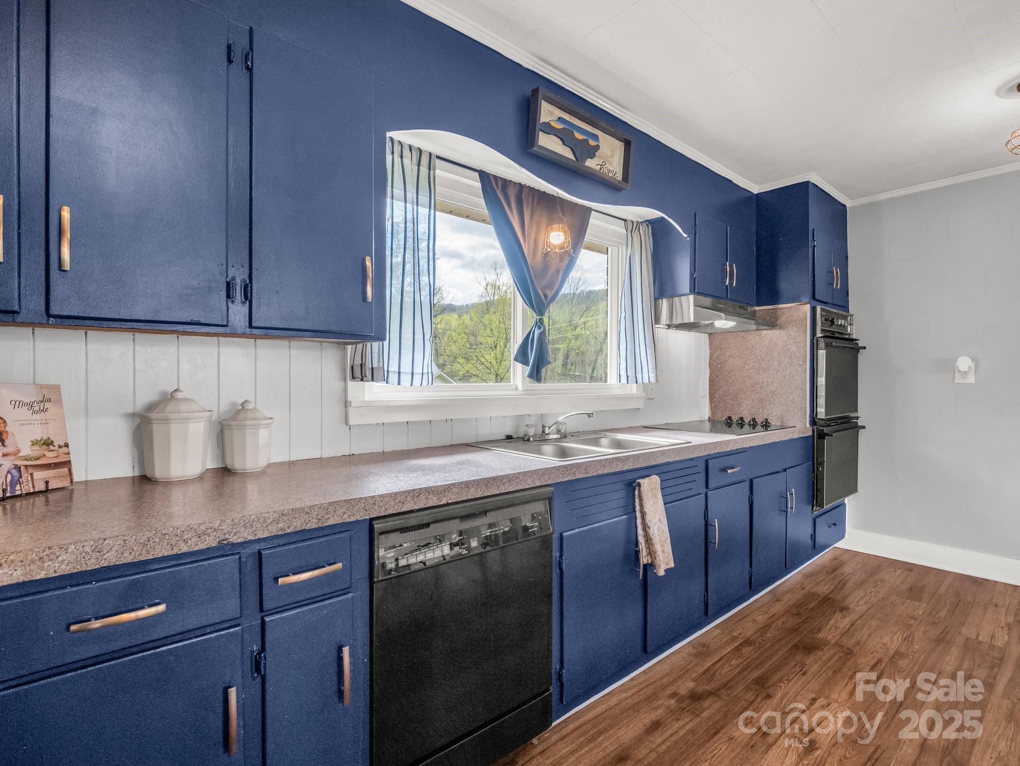 88 North Valley Street Marion, NC 28752 - Photo 12 of 43 a kitchen with granite countertop stainless steel appliances a sink window and cabinets