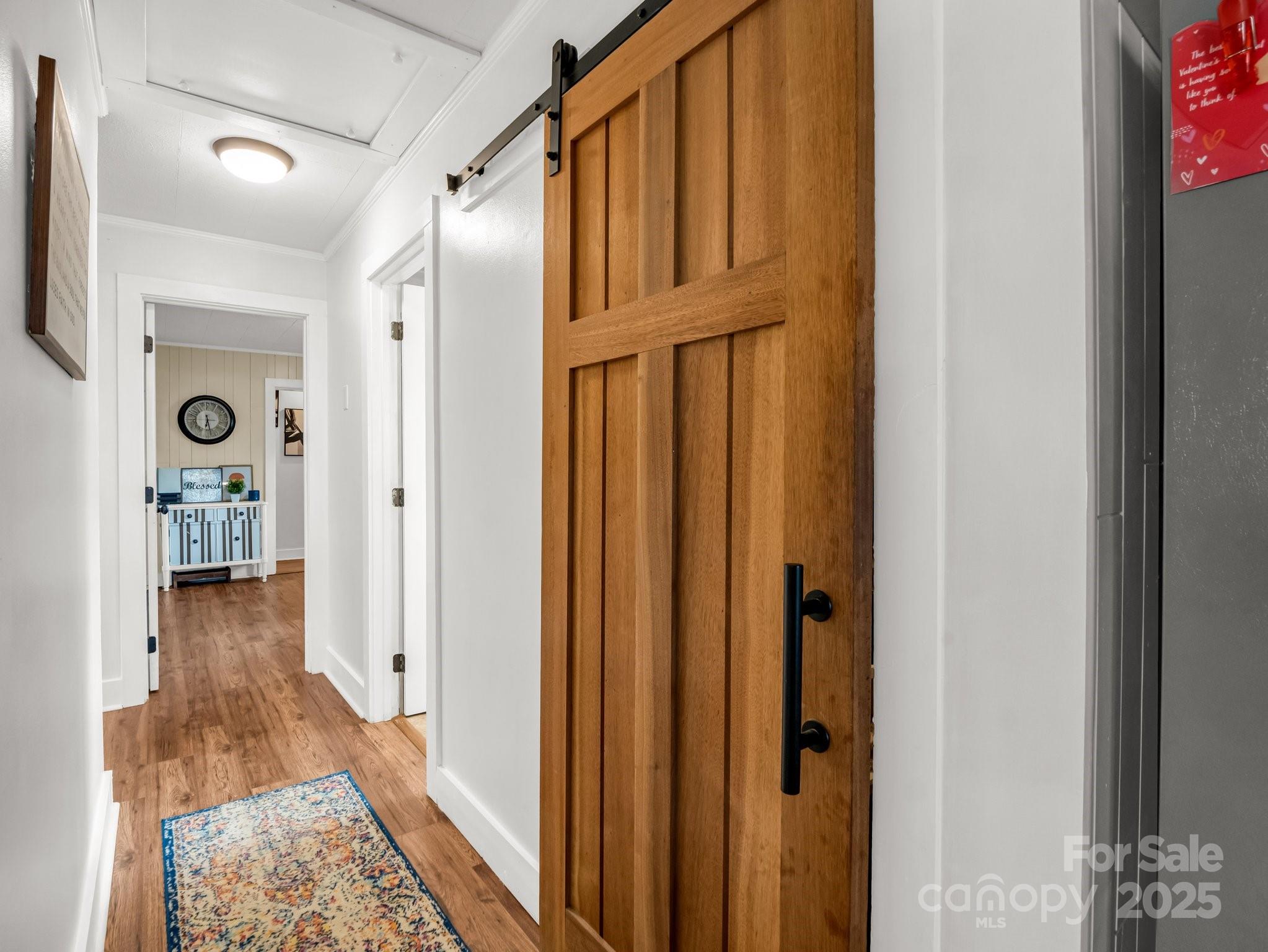 88 North Valley Street Marion, NC 28752 - Photo 13 of 43 a view of a hallway with wooden floor and a bathroom