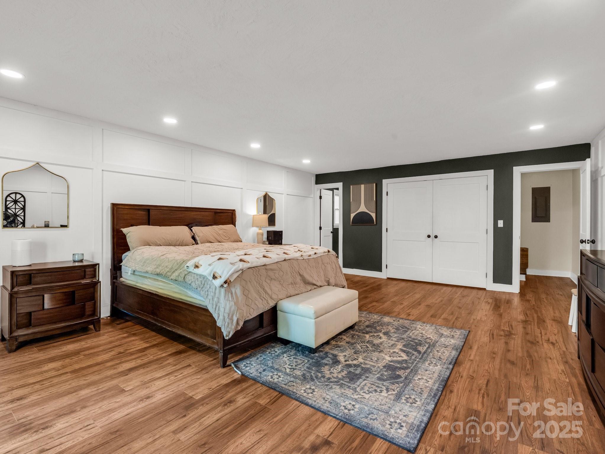 88 North Valley Street Marion, NC 28752 - Photo 15 of 43 a bedroom with a bed and wooden floor