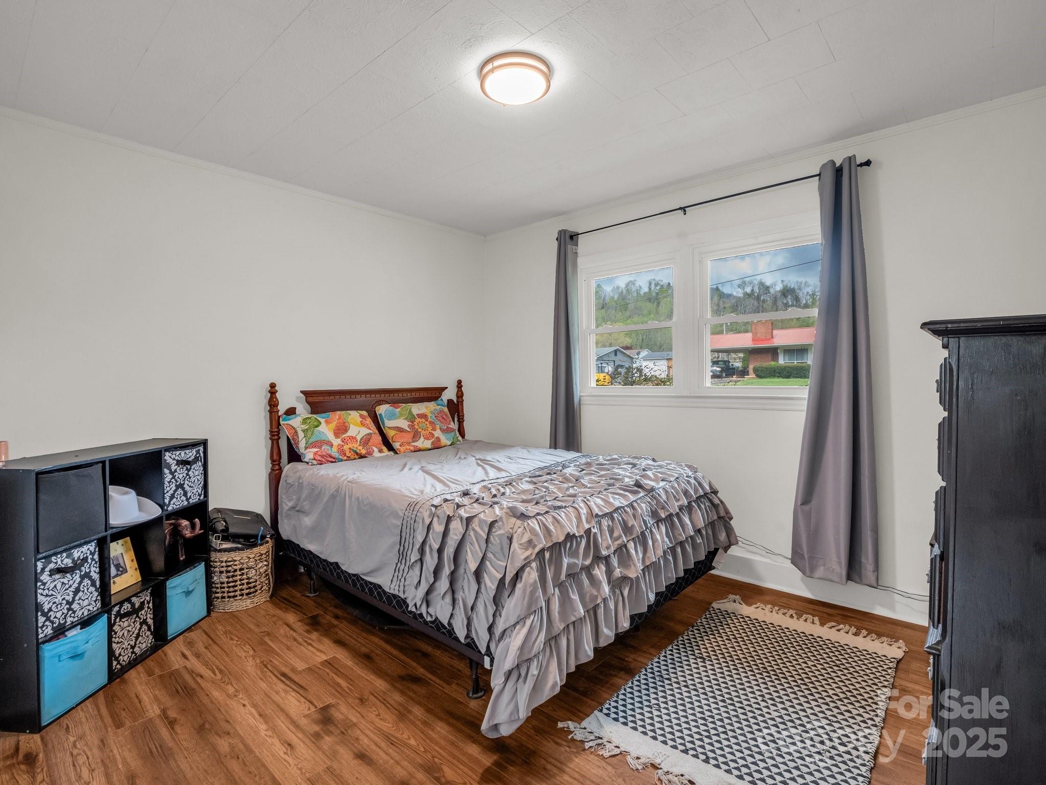 88 North Valley Street Marion, NC 28752 - Photo 18 of 43 a bedroom with a bed and a window