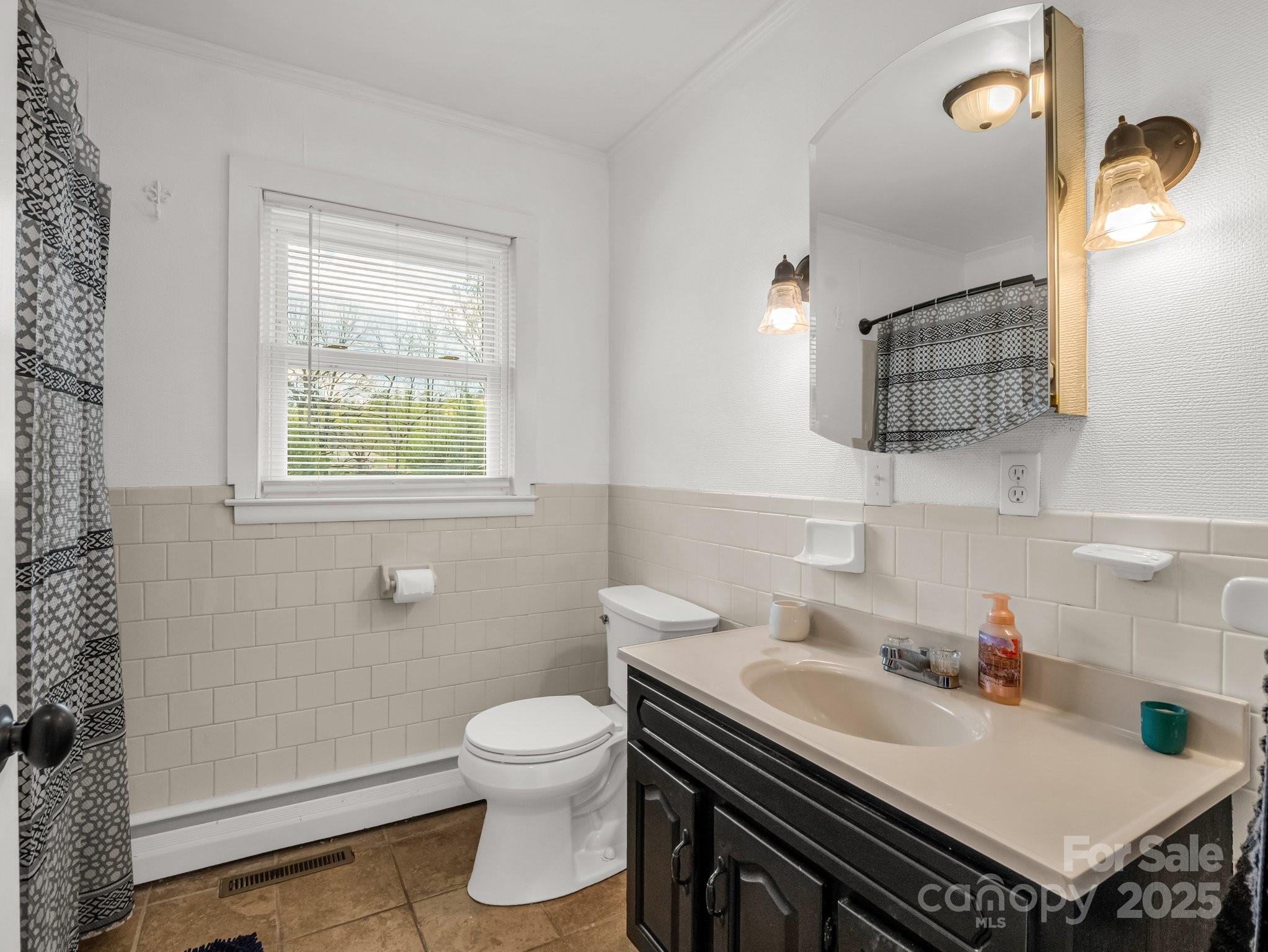 88 North Valley Street Marion, NC 28752 - Photo 20 of 43 a bathroom with a sink toilet and shower