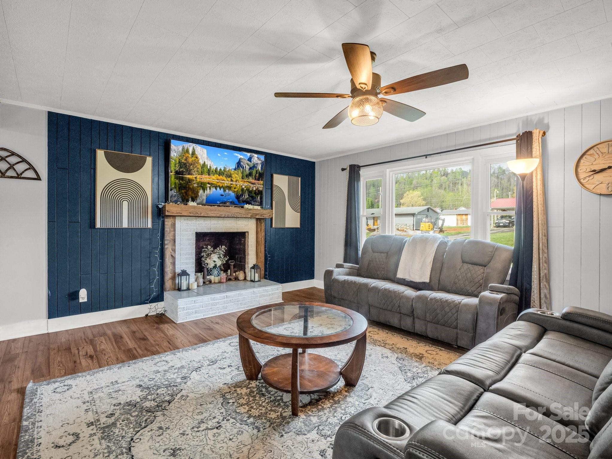 88 North Valley Street Marion, NC 28752 - Photo 2 of 43 a living room with furniture a window and a fireplace