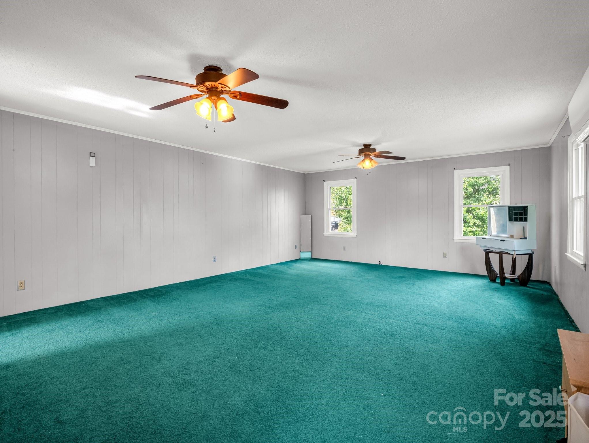 88 North Valley Street Marion, NC 28752 - Photo 27 of 43 a view of a livingroom with hardwood floor and a ceiling fan