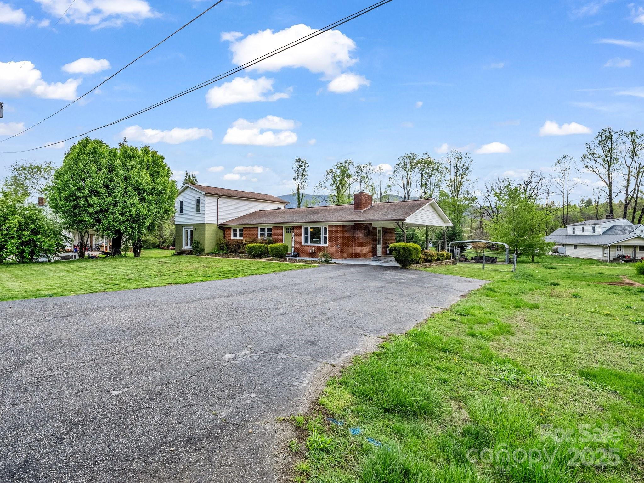 88 North Valley Street Marion, NC 28752 - Photo 42 of 43 a yellow and red house with a yard