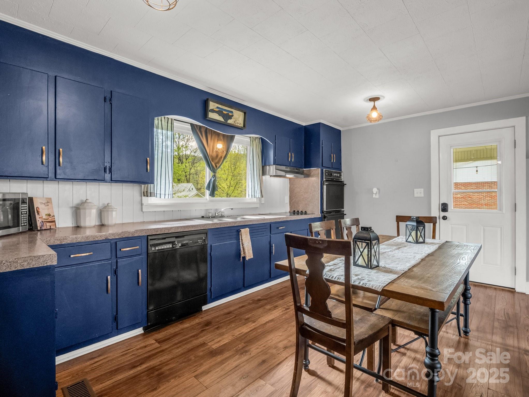88 North Valley Street Marion, NC 28752 - Photo 8 of 43 a kitchen with a wooden table and chairs