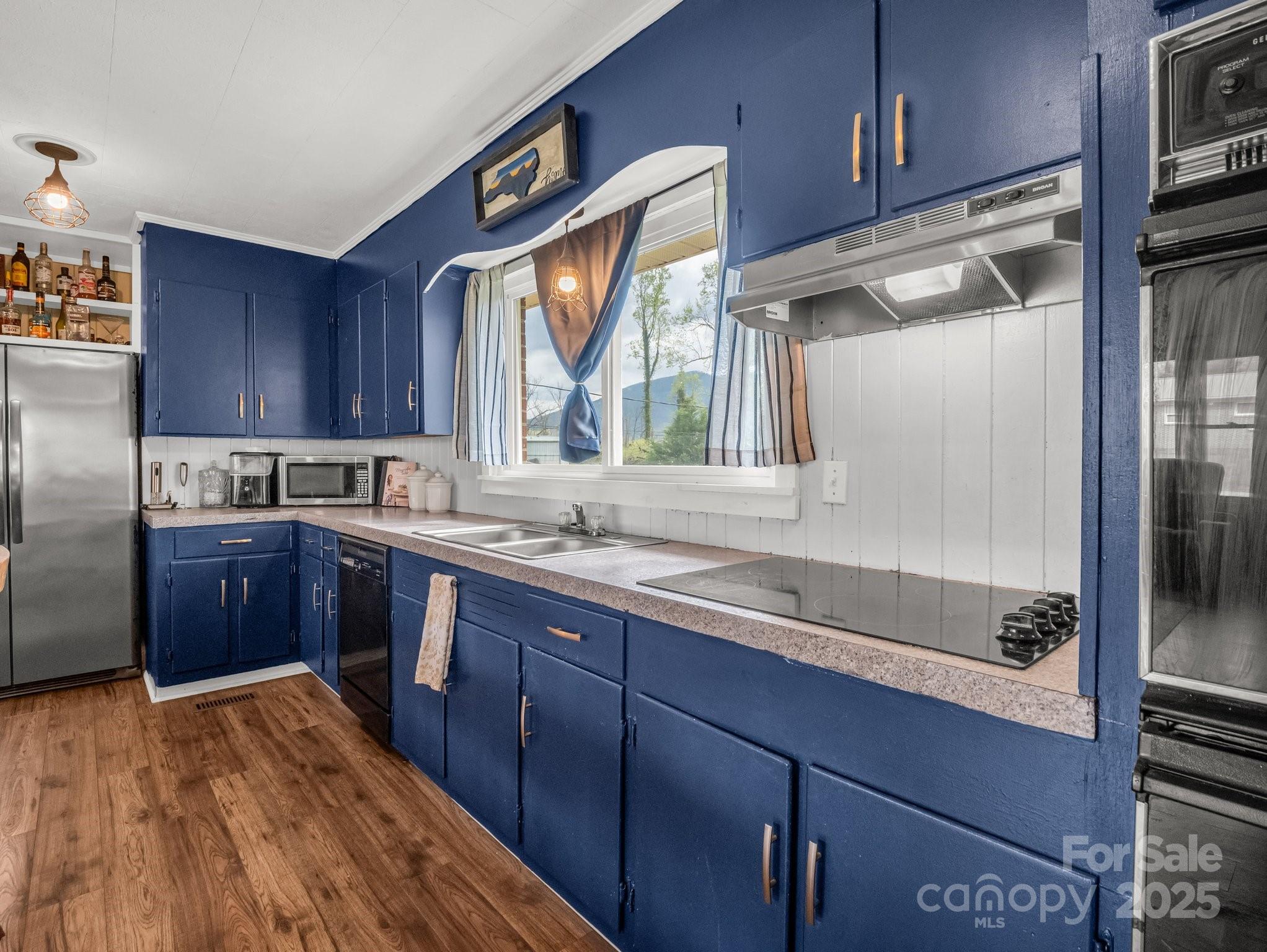 88 North Valley Street Marion, NC 28752 - Photo 10 of 43 a kitchen with a sink window and cabinets