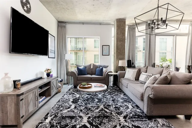 a living room with furniture and a flat screen tv