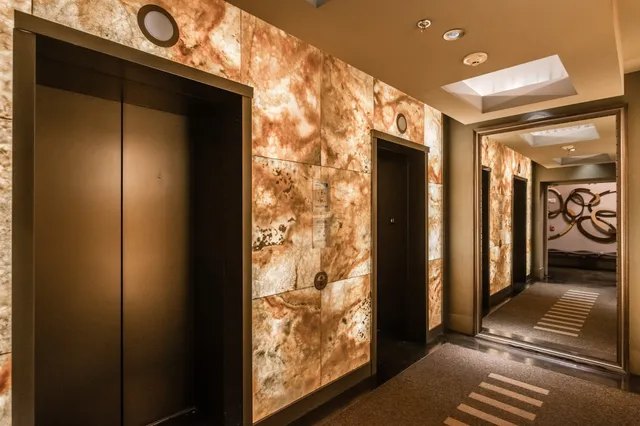 a living room with couches and kitchen view