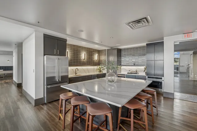 a dining room with lots of wooden furniture and wooden floor