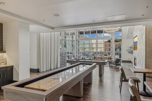 a view of a patio with dining table and chairs with a barbeque