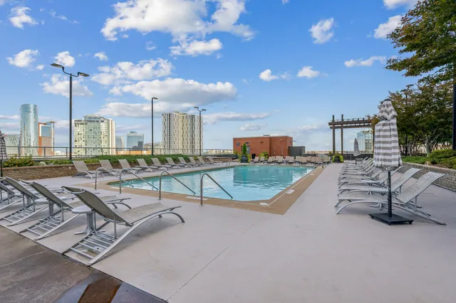 a view of a livingroom with wooden floor and a ceiling fan