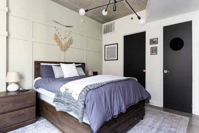 a bedroom with bed and window