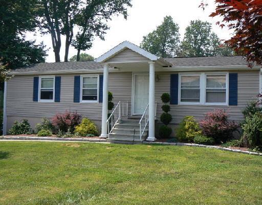 4 High Acres Road Ansonia, CT 06401 - Photo 1 of 1 a front view of a house with a garden