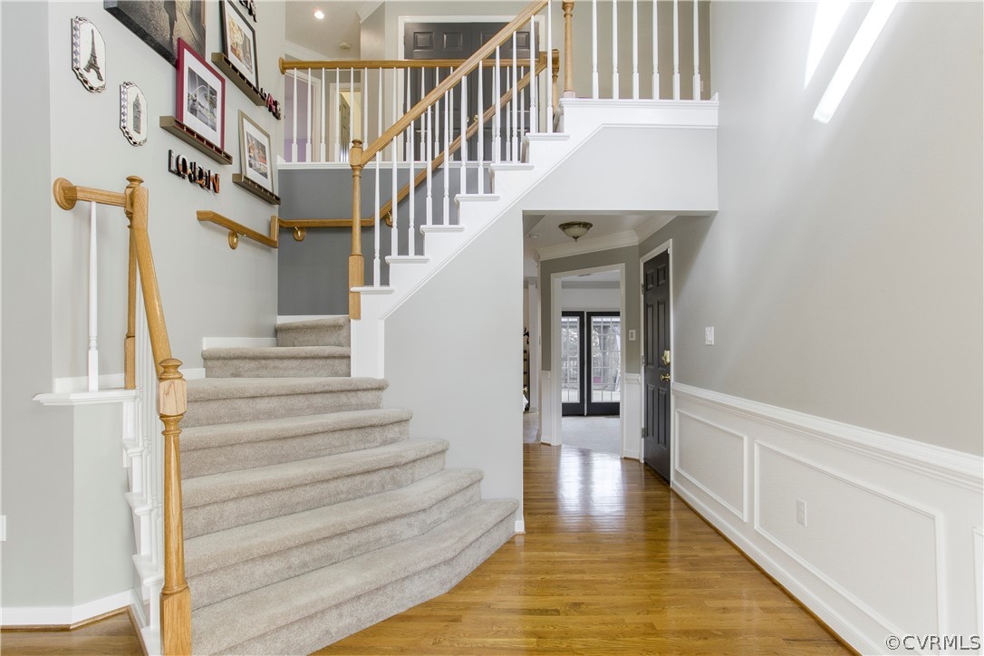 5530 Houndmaster Road Midlothian, VA 23112 - Photo 3 of 33 a view of staircase with lots of frames on wall and a window