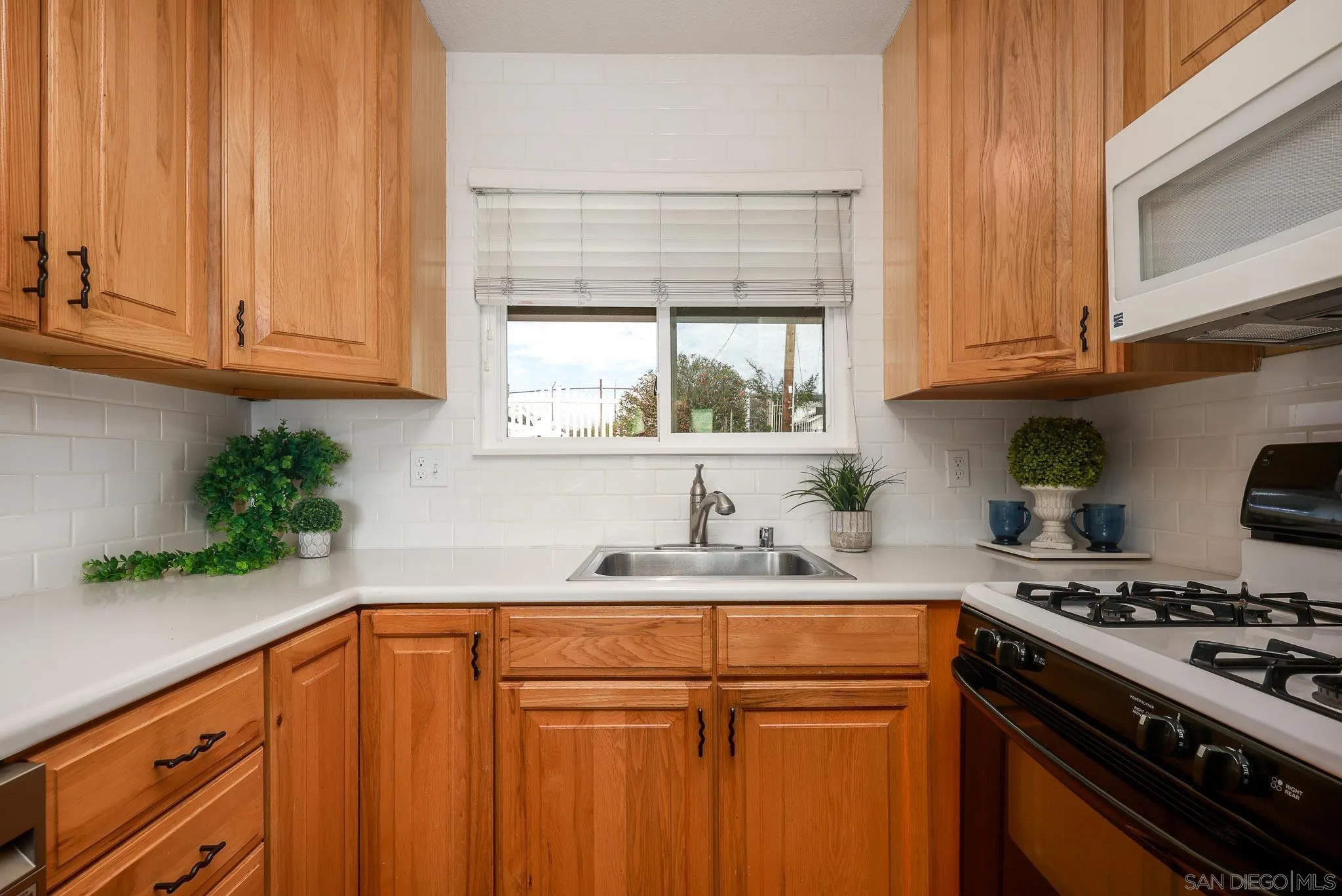 11739 Walnut Road Lakeside, CA 92040 - Photo 13 of 32 a kitchen with granite countertop a sink stainless steel appliances and cabinets