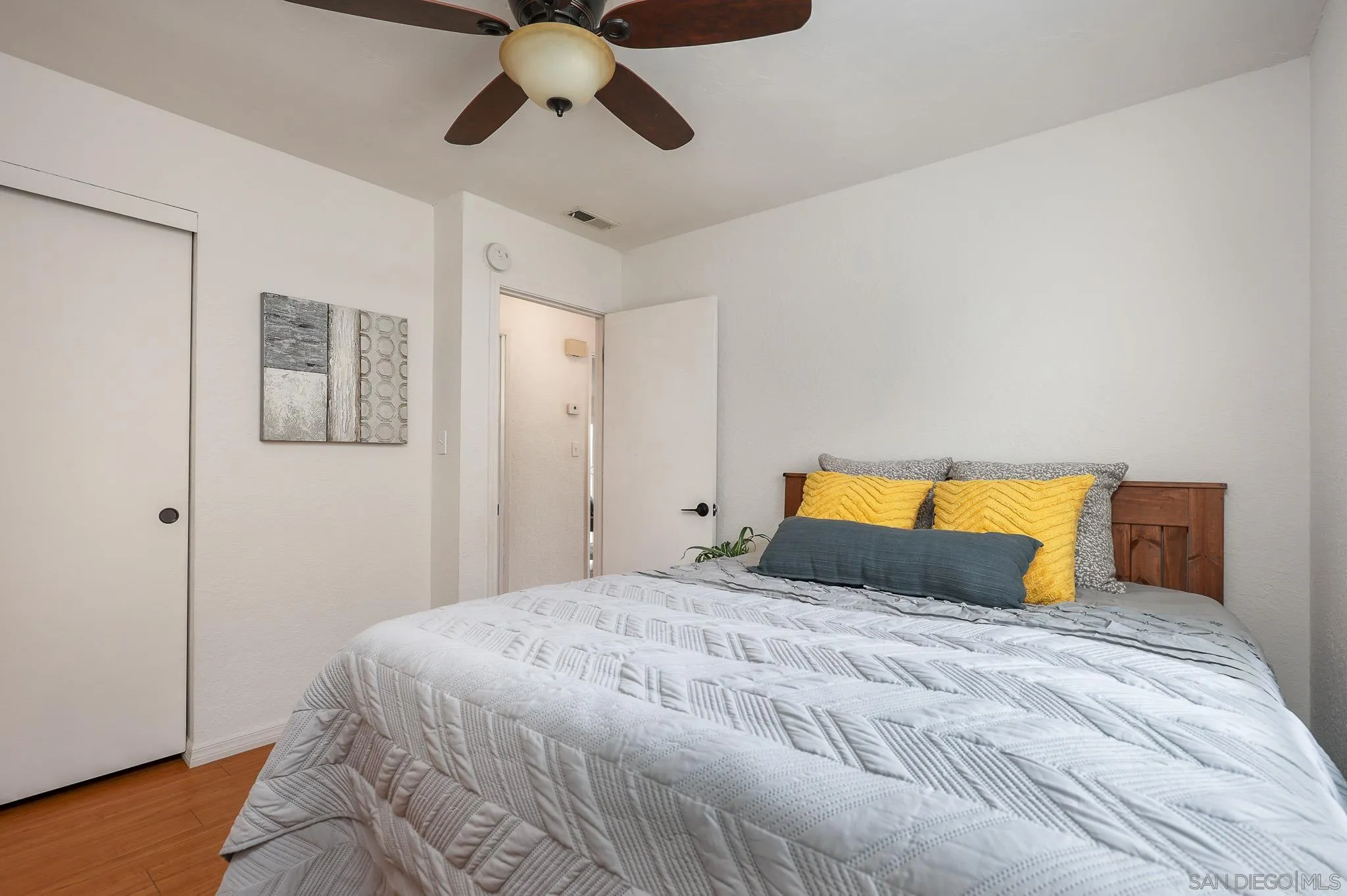 11739 Walnut Road Lakeside, CA 92040 - Photo 16 of 32 a bedroom with a large bed and a chandelier