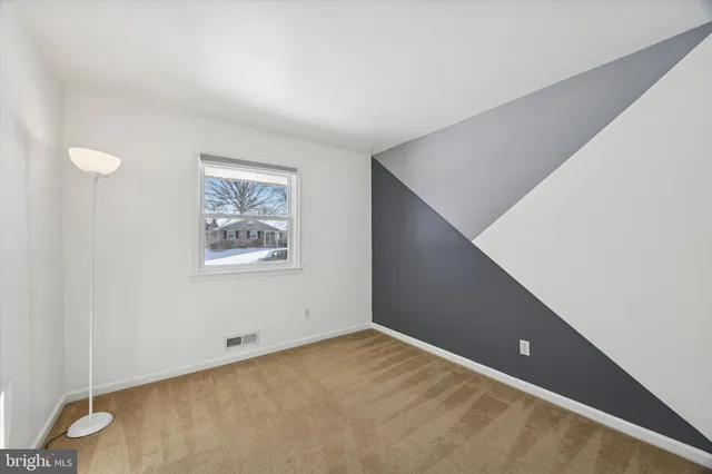 a view of an empty room with windows