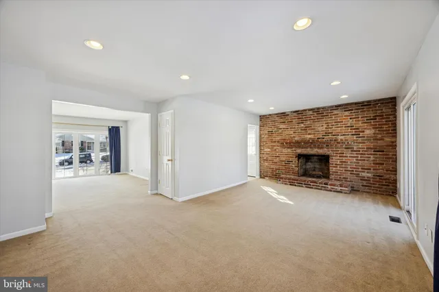 a view of an empty room with a fireplace