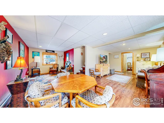 a living room with furniture a fireplace and a sink