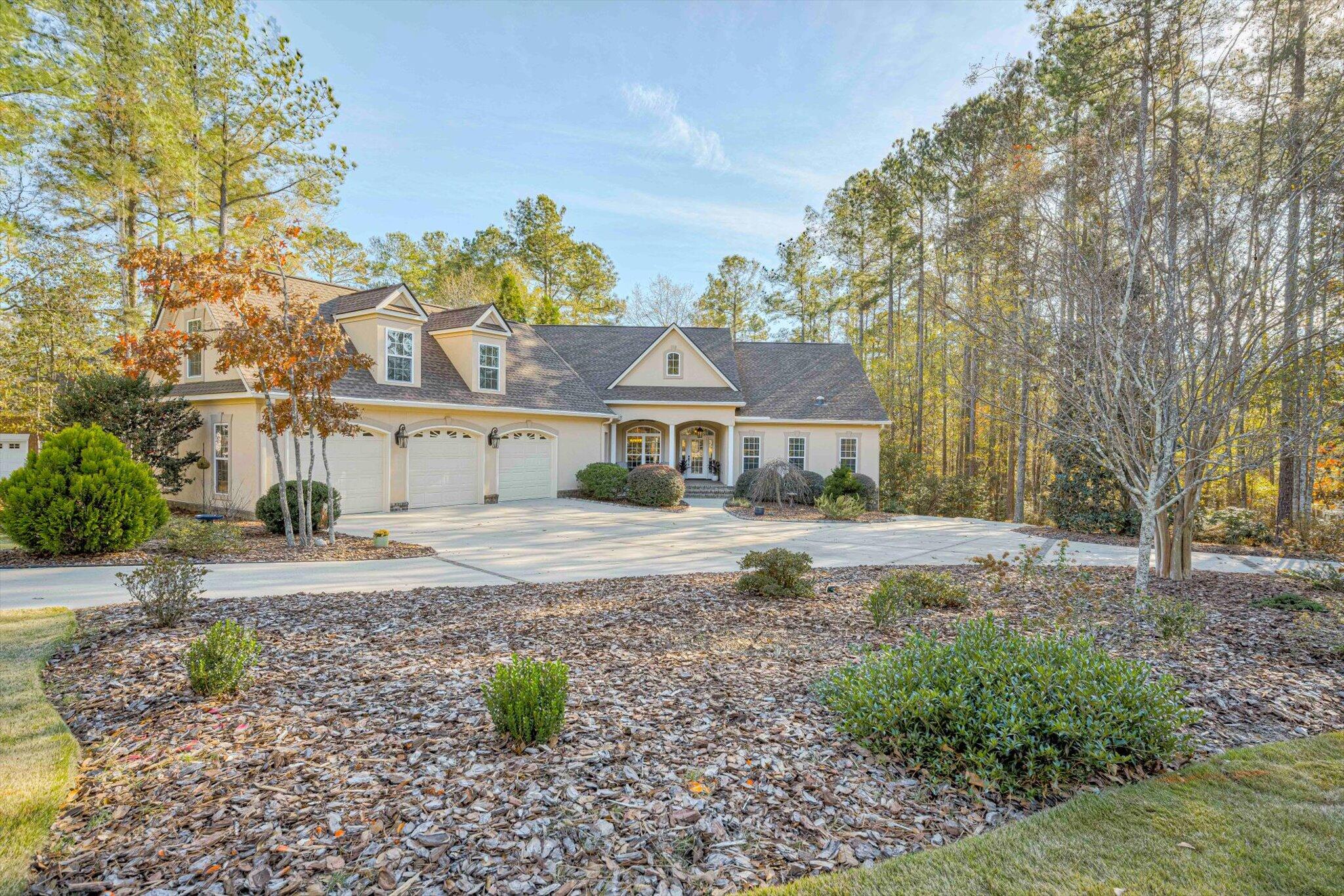 Beautiful, custom home with 3-car garage is found in the heart of Aiken's
Cedar Creek amenity-rich community!