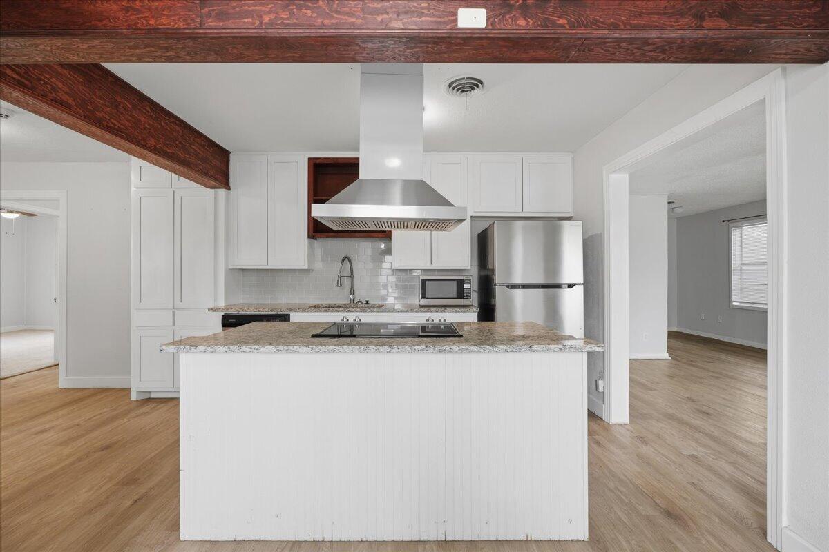 2503 30th Street Lubbock, TX 79410 - Photo 8 of 26 a kitchen with stainless steel appliances granite countertop a sink and a refrigerator